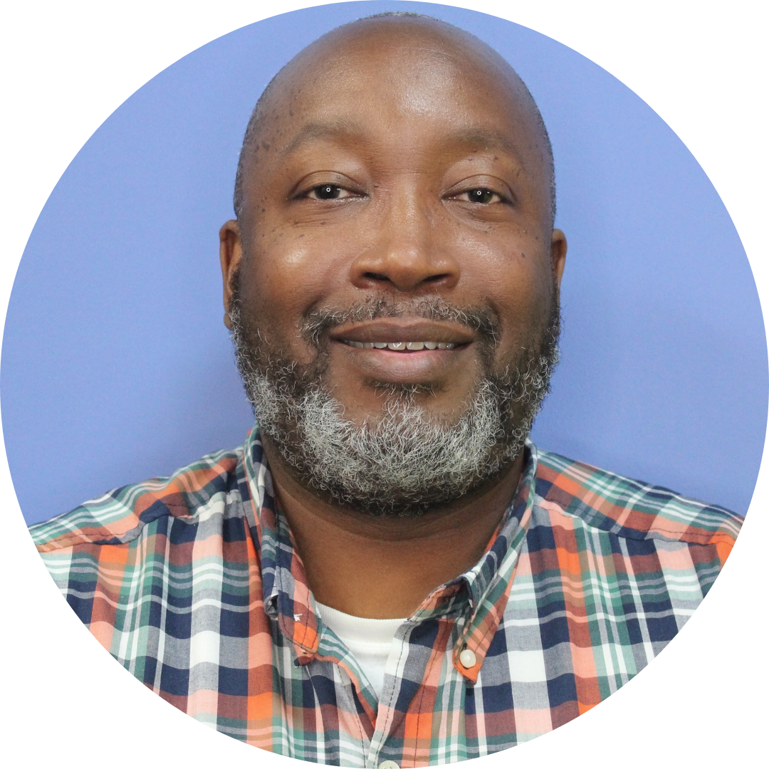 Antoine James wearing a plaid shirt in front of a blue background